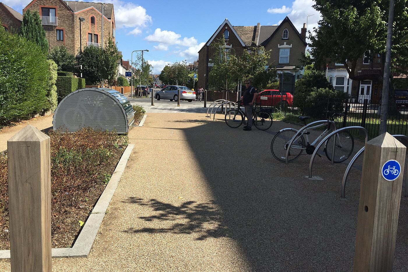 Mini-Hollands in London: Grün- und Flanierfläche mit Fahrradparkplätzen. Mini-Hollands in London: Grün- und Flanierfläche mit Fahrradparkplätzen.